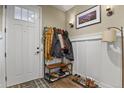 Functional entryway with coat rack, shoe storage, and stylish decor at 7976 E 53Rd Dr, Denver, CO 80238