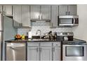 Well-maintained kitchen with stainless steel appliances, granite countertops, and subway tile backsplash at 529 N Washington St # 304, Denver, CO 80203