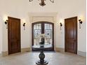 Elegant entryway with double doors, a round table, and a chandelier at 1043 Meteor Pl, Castle Rock, CO 80108