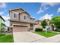 Inviting two-story home with a two-car garage, stone accents, and a 'For Sale' sign on the lawn at 3565 E 141St Dr, Thornton, CO 80602