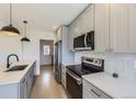 Contemporary kitchen featuring stainless steel appliances and white subway tile backsplash at 3201 Albion St, Denver, CO 80207