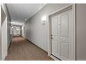 Apartment 401, long hallway with carpet, leading to various units in the building at 1044 Rockhurst Dr # 401, Highlands Ranch, CO 80129