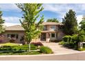 Charming home with well-maintained lawn, mature trees, a welcoming front entry, and three-car garage at 2535 W 115Th Dr, Denver, CO 80234