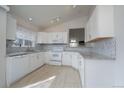 Well-lit kitchen featuring a full suite of appliances and stylish backsplash at 2991 S Zeno Way, Aurora, CO 80013