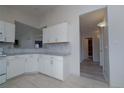 Well-lit kitchen features light granite countertops and leads to adjoining rooms at 2991 S Zeno Way, Aurora, CO 80013