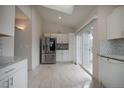 Bright kitchen features stainless steel appliances and access to the backyard at 2991 S Zeno Way, Aurora, CO 80013
