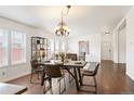 Inviting dining room featuring hardwood floors, a modern chandelier, and ample natural light at 1522 Willow St, Denver, CO 80220