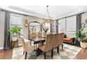 Elegant dining room featuring modern chandelier, large mirror, and stylish decor, perfect for gatherings at 12968 Reata Ridge Dr, Parker, CO 80134