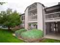 Charming condo exterior with beautiful green space, a balcony, and well-maintained landscaping at 9263 E Arbor Cir # B, Englewood, CO 80111
