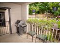 Outdoor patio area featuring a grill, quaint patio furniture, and floral accents at 9263 E Arbor Cir # B, Englewood, CO 80111