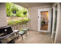 Relaxing patio space with grill, flowers, and an inviting entryway into the home at 9263 E Arbor Cir # B, Englewood, CO 80111