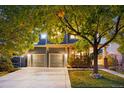 Inviting home exterior with a large driveway and well-kept lawn, perfect for Gathering living at 16456 Wagon Pl, Parker, CO 80134