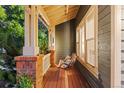 Cozy covered front porch with a relaxing porch swing, perfect for enjoying the outdoors at 16456 Wagon Pl, Parker, CO 80134