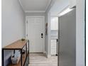 Inviting entryway with coat hooks, modern console table, and open access to kitchen at 7201 E Quincy Ave # 103, Denver, CO 80237
