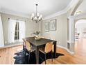 Elegant dining room with stylish chandelier, hardwood floors, and sophisticated decor at 7899 E 28Th Pl, Denver, CO 80238