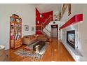 Bright living room with hardwood floors, fireplace, and access to upper level at 3310 W 98Th Ave # B, Westminster, CO 80031