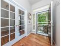 Welcoming foyer with hardwood floors, glass paneled doors, and a view of the front porch at 1873 Trevor Cir, Longmont, CO 80501