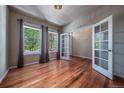 Bright office space with hardwood floors, large windows, and glass paneled doors at 1873 Trevor Cir, Longmont, CO 80501