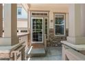 Inviting front porch with stone accents, a welcome mat, and ample natural light at 1873 Trevor Cir, Longmont, CO 80501