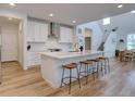 Open concept kitchen with a large island, bar stool seating, and modern stainless hood at 11246 Bellsong Ln, Littleton, CO 80125