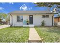 Charming single-story home with a well-maintained lawn and inviting front entrance at 7001 Alan Dr, Denver, CO 80221