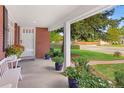 Inviting front porch adorned with potted plants and bench, providing a charming outdoor seating area at 3450 E Easter Ave, Centennial, CO 80122