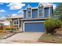 Charming two-story home features a blue exterior, attached garage, and manicured landscaping at 325 Mulberry Cir, Broomfield, CO 80020