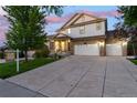 Beautiful two-story home with a well-maintained lawn, stone accents, three car garage and covered porch at 6236 S Millbrook Way, Aurora, CO 80016