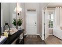 Inviting foyer with hardwood floors, white door, a console table, mirror and elegant decor at 6236 S Millbrook Way, Aurora, CO 80016