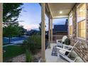 Charming front porch with stone accents, rocking chairs, and picturesque neighborhood views at 6236 S Millbrook Way, Aurora, CO 80016