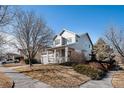 Well-maintained two-story home with a covered front porch and manicured landscaping on a sunny day at 11499 Kenton St, Commerce City, CO 80640