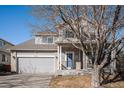 Inviting two-story home with a two-car garage and covered front porch, highlighted by a well-kept front yard at 11499 Kenton St, Commerce City, CO 80640