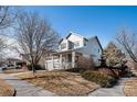 Well-kept two-story home featuring a covered front porch and manicured landscaping at 11499 Kenton St, Commerce City, CO 80640