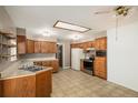 Well-lit kitchen features wood cabinets and an appliance package at 406 Titan Ct, Aurora, CO 80011