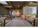 Inviting front porch featuring stone accents, wood door, and ample space for relaxation at 23774 E 36Th Pl, Aurora, CO 80019