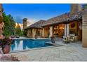 Outdoor pool and patio with view of luxurious house, and an outdoor sitting area with lounge chairs at 45 Charlou Cir, Cherry Hills Village, CO 80111