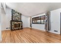 Living room with hardwood floors and stone fireplace at 3142 Uvalda St, Aurora, CO 80011