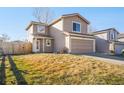 Inviting two-story home with a two-car garage and a well-manicured front yard in a suburban neighborhood at 3829 Odessa St, Denver, CO 80249