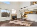 Bright living room with hardwood floors, fireplace, and ample natural light from large windows at 3829 Odessa St, Denver, CO 80249