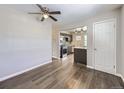 Living room with hardwood floors, ceiling fan, and view of kitchen at 3259 N Adams St, Denver, CO 80205