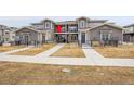 Exterior of townhome features a fenced front yard and cozy balcony, enhanced by a well-maintained landscape at 330 High Point Dr # B102, Longmont, CO 80504