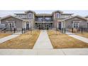 Exterior view of townhome showcases landscaped front yards, balconies, and shared walkway to each unit at 330 High Point Dr # B102, Longmont, CO 80504