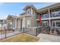 Exterior view of townhome features a fenced front yard and a balcony, enhancing curb appeal at 330 High Point Dr # B102, Longmont, CO 80504