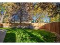 Large, grassy backyard with wooden fence at 7904 Chase Cir # 146, Arvada, CO 80003