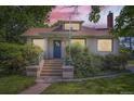 Inviting home entrance with concrete steps, decorative planters, and a secure front door at 3246 W 53Rd Ave, Denver, CO 80221