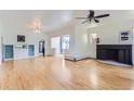 Bright living room with hardwood floors, fireplace, ceiling fan, and built-in storage at 3246 W 53Rd Ave, Denver, CO 80221