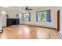 Comfortable living room featuring a fireplace, hardwood floors and large windows at 3246 W 53Rd Ave, Denver, CO 80221
