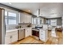 Beautiful kitchen with stainless steel appliances, mosaic backsplash, and an open layout at 3171 W 38Th Ave, Denver, CO 80211