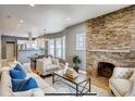 Bright living room featuring a stone fireplace, hardwood floors, and open concept design at 3171 W 38Th Ave, Denver, CO 80211