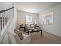 Comfortable living space with natural light, complemented by neutral tones and a modern seating arrangement at 9608 Albion Ln, Thornton, CO 80229